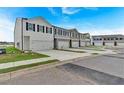 Street view of new townhouses showing garages and sidewalks, with well-kept landscaping at 8656 Webb Rd, Riverdale, GA 30274