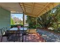 Comfortable side porch with a table, surrounded by lush greenery, perfect for outdoor dining at 1976 Northside Nw Dr, Atlanta, GA 30318