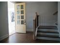 Bright entryway with hardwood floors, staircase, and a charming glass-paneled front door at 316 Oak Arms Way, Woodstock, GA 30188