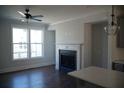 Cozy living room with a fireplace, large window, hardwood floors, and modern finishes at 316 Oak Arms Way, Woodstock, GA 30188
