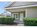 Inviting covered front porch with green hedges, leading to a white security door at 848 Capitol View Nw Ave, Atlanta, GA 30318