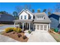 Charming two-story home with a welcoming front porch and a well-manicured landscaped yard at 2434 Soft Maple St, Atlanta, GA 30360