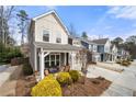 View of multiple similar homes on a street with manicured lawns and driveways leading to attached garages at 2434 Soft Maple St, Atlanta, GA 30360