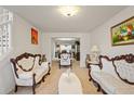 Bright and airy living room with classic decor and an open layout leading to the dining area at 1893 Tulip Petal Rd, Auburn, GA 30011