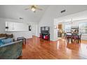 Open concept living room with hardwood floors, vaulted ceiling, and bright light at 6517 Brenda Ann Dr, Lithonia, GA 30058