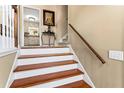 Elegant staircase with wooden steps, white risers, and a classic wooden handrail at 13 Greystone Nw Ln, Cartersville, GA 30121