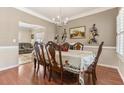 Formal dining room with hardwood floors, elegant chandelier, and ample seating at 134 Paces Lakes Overlook, Dallas, GA 30157