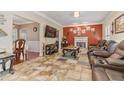 Relaxing living room with a cozy fireplace, neutral paint colors, and tile flooring at 134 Paces Lakes Overlook, Dallas, GA 30157