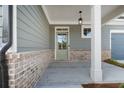 Charming front porch featuring brick accents, neutral siding, and a stylish entrance door, creating a welcoming space at 306 Bunker Hill Ct, Acworth, GA 30102