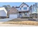 Beautiful two-story home featuring a brick facade, inviting front porch, and a well-manicured lawn at 3328 Sir Gregory Mnr, Lawrenceville, GA 30044