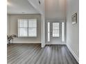 Spacious foyer with high ceilings, a white front door, and wide plank floors at 3328 Sir Gregory Mnr, Lawrenceville, GA 30044