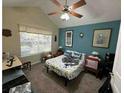 Cozy bedroom features a ceiling fan, neutral carpet, and a bright window for natural light at 2191 Rockbridge Road, Stone Mountain, GA 30087