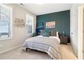 Cozy bedroom with a large bed, accent wall, and plenty of natural light from the windows at 2435 Folly Se Ln, Atlanta, GA 30339