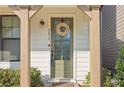 Close-up of the front door featuring a wreath, address numbers, and a covered porch at 2435 Folly Se Ln, Atlanta, GA 30339