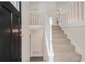 Bright entryway featuring a staircase with white railings and a view of the upper level at 3875 Mcgill Way, Decatur, GA 30034