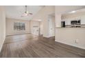 Open-concept living room with hardwood floors, a ceiling fan, and large windows at 3875 Mcgill Way, Decatur, GA 30034