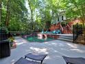 An inviting in-ground pool with surrounding deck space for lounging and a lush, private backyard setting at 7440 Princeton Trce, Sandy Springs, GA 30328