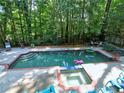 Large outdoor pool with a spa, tanning chairs, and a well-kept pool deck at 7440 Princeton Trce, Sandy Springs, GA 30328