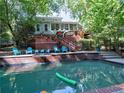 Outdoor pool with tanning chairs, a waterfall feature, and a well-kept pool deck at 7440 Princeton Trce, Sandy Springs, GA 30328