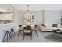 Cozy dining area with stylish light fixture, table, and seamless transition to the living room at 1101 Juniper Ne St # 722, Atlanta, GA 30309