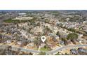 Aerial view of home in a neighborhood showing nearby community, streets, and wooded areas at 340 Ruby Forest Pkwy, Suwanee, GA 30024