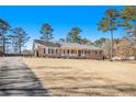 Well-maintained single-story home with a lush front yard and a long driveway, perfect for parking at 345 Wedgefield Dr, Mcdonough, GA 30252