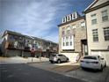 Street view of newly constructed townhomes with well-maintained landscaping and attached garages at 1411 Wisteria Wall Dr, Suwanee, GA 30024