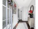 Bright foyer featuring hardwood floors, a stylish mirror, and elegant decor at 3180 Spicy Cedar Ln, Lithonia, GA 30038