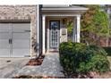 Inviting front entrance with a well-manicured bush and a charming wreath on the front door at 3180 Spicy Cedar Ln, Lithonia, GA 30038