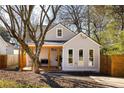 Charming bungalow with a welcoming front porch and modern gray siding, complemented by a neatly landscaped yard at 731 Hobart Se Ave, Atlanta, GA 30312