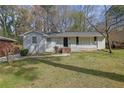 Traditional-style home with brick facade, offering a welcoming front yard with mature tree at 3532 Dial Dr, Stone Mountain, GA 30083