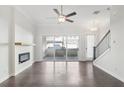 Living room with a ceiling fan, fireplace, and sliding glass doors leading to the outdoor patio at 671 Stickley Oak Way, Woodstock, GA 30189
