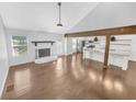 A well-lit living room with hardwood floors, a fireplace and open view to the modern kitchen at 2473 Chauncey Sw Ln, Marietta, GA 30064