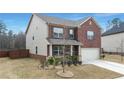 Beautiful two-story home with brick and siding, a well-manicured lawn, and an attached garage at 3062 Hawthorn Farm Blvd, Loganville, GA 30052