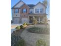 Charming two-story house boasting a blend of brick and siding, accented by dark shutters and a well-manicured front yard at 736 Great Oak Pl, Villa Rica, GA 30180