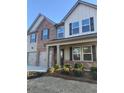 Inviting two-story home with a mix of brick and siding, featuring a double garage and meticulously landscaped front garden at 736 Great Oak Pl, Villa Rica, GA 30180