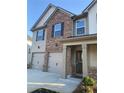 Classic two-story home showcasing a combination of brick and siding, complete with an attached two-car garage and neat landscaping at 736 Great Oak Pl, Villa Rica, GA 30180