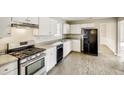 Functional kitchen with stainless steel appliances, sleek counters, and ample cabinet space at 2921 Russ Ln, Lithonia, GA 30058