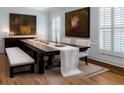 Traditional dining room with dark wood table, shuttered windows, and decorative paintings at 3529 S Sherwood Se Rd, Smyrna, GA 30082