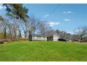 Charming single Gathering home with an inviting front yard and a private driveway at 145 Pinehurst Dr, Stockbridge, GA 30281