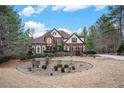 Beautiful brick home showcasing meticulous landscaping and a circular driveway at 3647 Little Spg, Stockbridge, GA 30281
