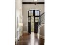 Elegant foyer with dark wood floors, staircase, and entry door with transom window at 4755 Columns Se Dr, Marietta, GA 30067