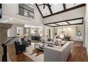 Open concept living room with high ceilings, exposed beams, and seamless flow to the kitchen at 4755 Columns Se Dr, Marietta, GA 30067