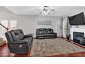 Spacious living room with a fireplace, hardwood floors, large windows, and comfortable seating at 2157 Capella Sw Cir, Atlanta, GA 30331