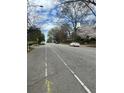 View of the neighborhood street with lush trees, vehicles and homes at 1771 Hosea L Williams Se Dr, Atlanta, GA 30317