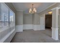 Spacious dining room with elegant wainscoting, chandelier, and ample natural light at 922 Gardenia Curv, Canton, GA 30114