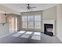 Open-concept living room with fireplace, large windows, and seamless flow to the dining area at 922 Gardenia Curv, Canton, GA 30114