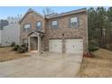 Lovely home featuring a two-car garage, inviting front entrance, and brick facade at 11930 Guelph Cir, Hampton, GA 30228