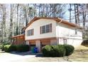 Side view of the home with a brick and siding exterior, and an attached garage at 3969 Briaridge Cir, Atlanta, GA 30340