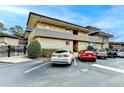 A multi-level apartment building with brick facade and well-maintained landscaping surrounded by ample parking at 346 Carpenter Dr # 29, Atlanta, GA 30328
